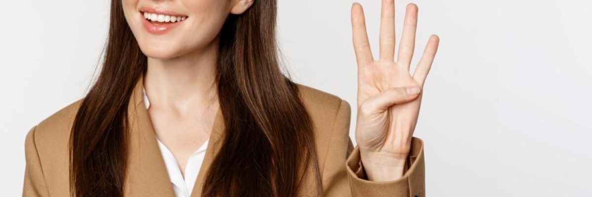 portrait-corporate-woman-saleswoman-showing-number-four-fingers-smiling-standing-suit-white-background (1)